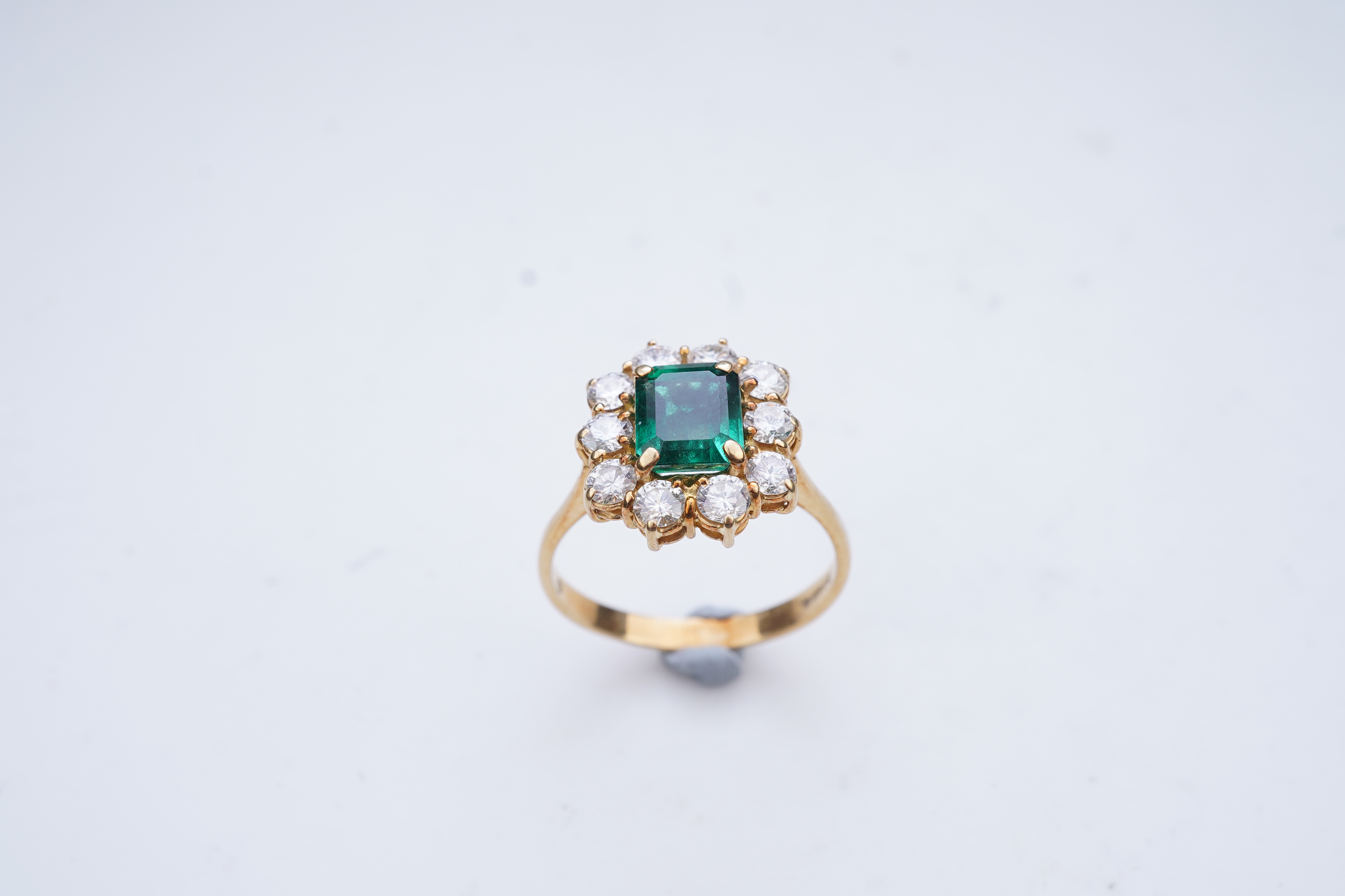 A synthetic emerald and diamond ring
